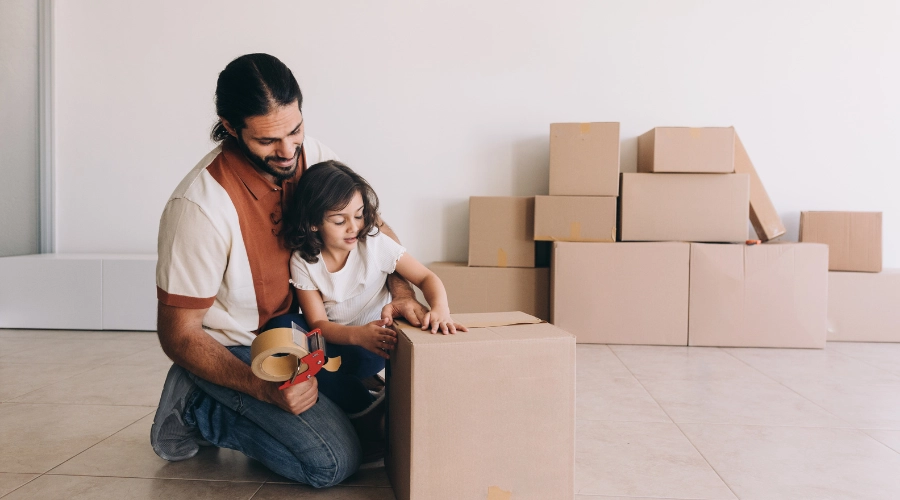 father and daughter surrounded by boxes