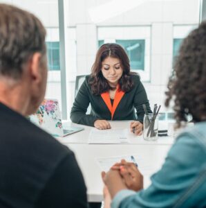 Divorcing couple meeting with a Bergen County divorce attorney to review legal documents and avoid divorce mistakes during a consultation.