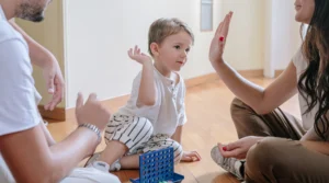 man and lady giving little boy high hive
