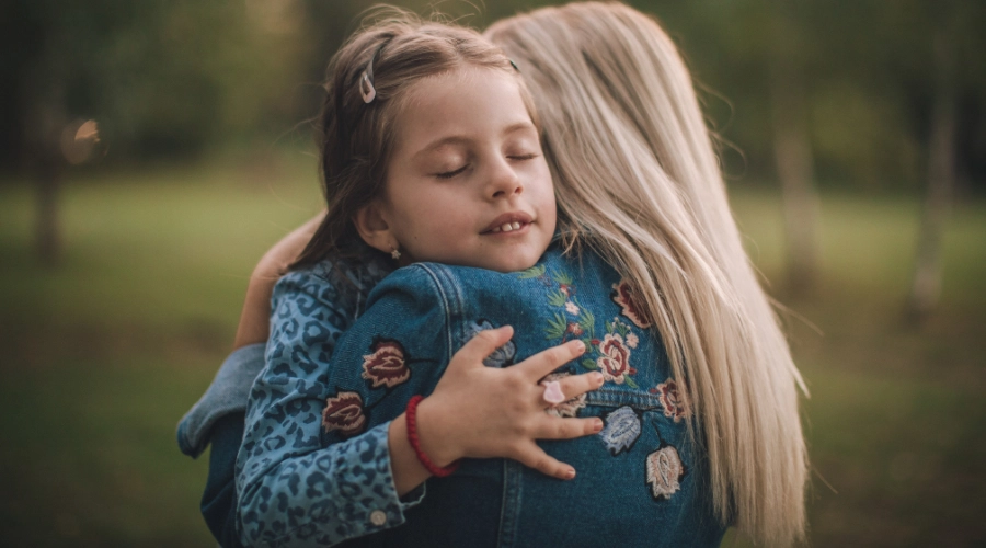 little girl hugging a lady
