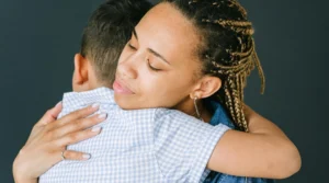 lady hugging a little boy